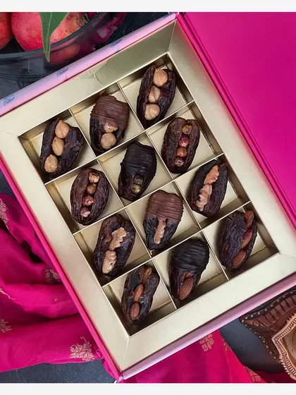For a healthier yet equally indulgent option, I offer this Gourmet Dates Box. It features premium Medjool dates, each one carefully stuffed with a delightful assortment of crunchy nuts like almonds and walnuts.