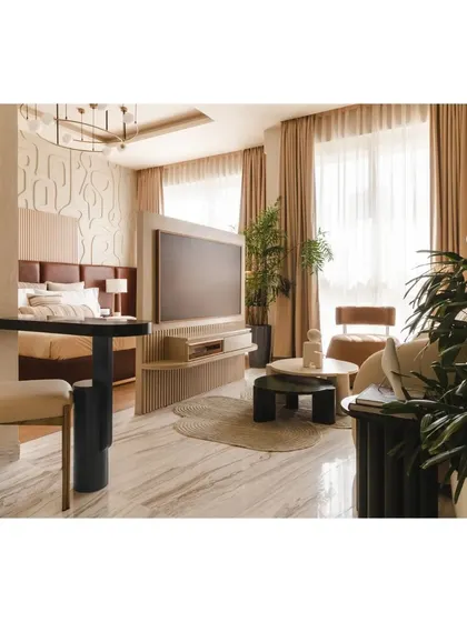 Another view of the open layout, showing how the living area and bedroom coexist harmoniously. The neutral color palette and ample natural light help make the 540 sqft space feel larger and more inviting.