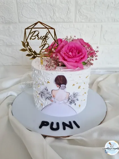 A super pretty off-white cake for a bride-to-be. I used a palette knife to create a textured finish and added a vibrant pink rose for a pop of color.