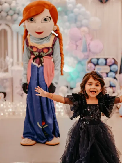 The birthday girl poses with an Anna mascot at her Frozen-themed party. We can arrange for character mascots to visit your event, creating priceless memories and interactions for the children.