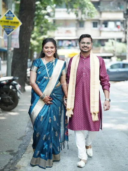 The happy couple taking a walk after their engagement. The bride's makeup looks fresh and flawless even outdoors in natural daylight.