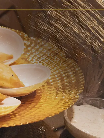 Another view of our savory pastries, served with a creamy dipping sauce. These classic Indian appetizers are always a crowd-pleaser at corporate events.