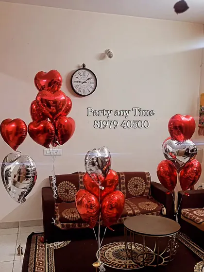 Simple anniversary decoration with red and silver heart-shaped helium balloons.