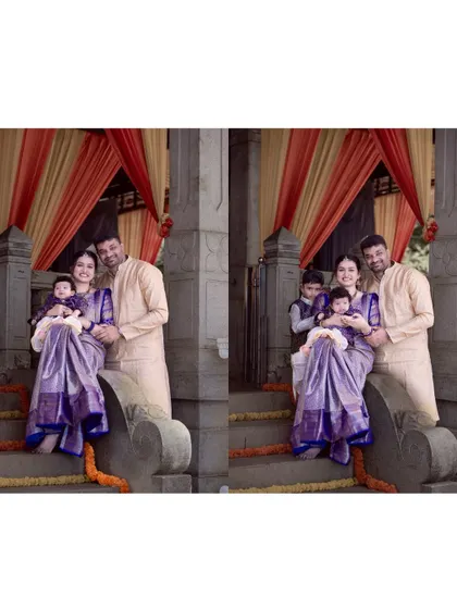 A formal family portrait from a naming ceremony. The family, including parents, a toddler, and a new baby, are posed together on steps, dressed in elegant traditional clothing.