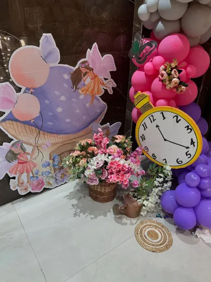 Whimsical cutouts of fairies and mushrooms used as decorative accents for an enchanted garden party.