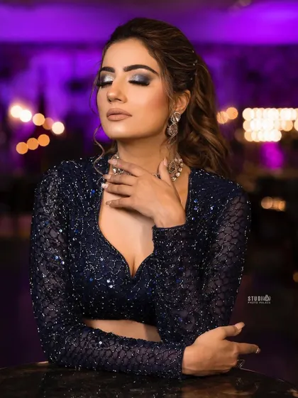 A dramatic shot with blue backlighting, highlighting the sparkle of the AD choker.