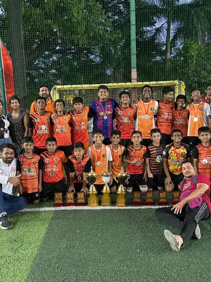 The team celebrating with all their trophies and medals after a successful Independence Cup.