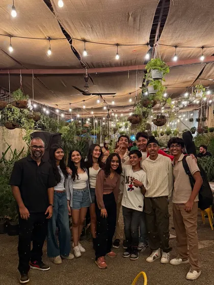 Another happy group picture from one of our evening events. The fairy lights and green backdrop make for a perfect photo opportunity.