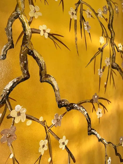 A close-up of the delicate, hand-sculpted flowers on the branches.