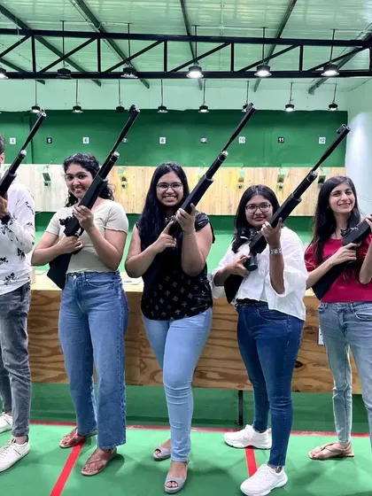 A group of friends proudly holding their air rifles after completing their introductory shooting session with us.