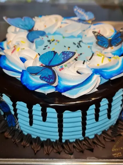 My Choco-Blueberry flavor with a beautiful butterfly theme. The blue frosting and chocolate drip are complemented by delicate, edible blue butterflies.