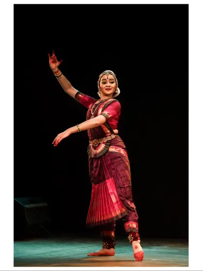 A graceful movement captured in a still photograph, showing the flow and elegance of the Thanjavur style.