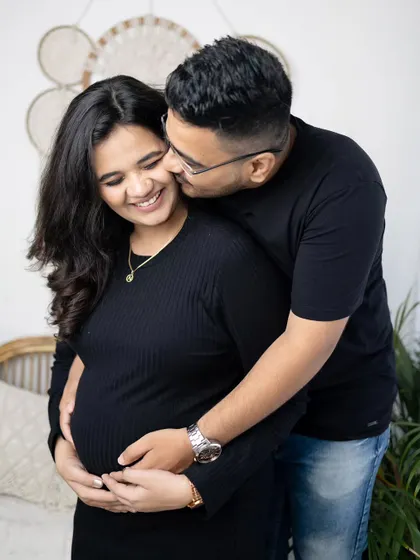 A sweet and playful moment between the couple. Capturing these natural interactions is key to a successful lifestyle maternity photoshoot.