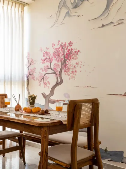 A close-up of the dining area, set against the beautiful hand-painted cherry blossom mural. This feature turns every meal into a special occasion.
