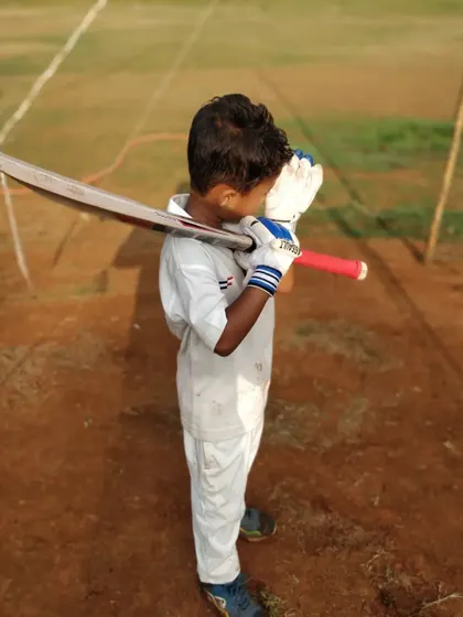 A young player holds his pose after playing a shot, a drill that helps reinforce correct technique and balance. We emphasize the importance of mastering these basics from day one.