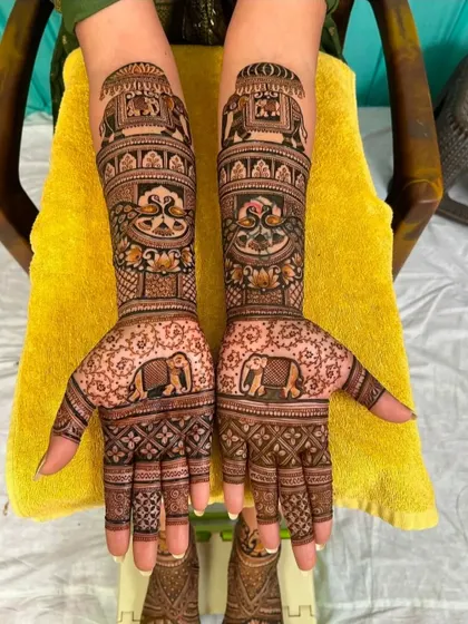 A classic elephant-themed design, with the majestic animals featured on both the palms and the forearms.