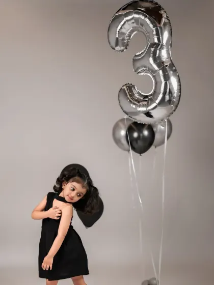 Posing with personality for her third birthday. We encourage kids to have fun and express themselves during their special photoshoot.