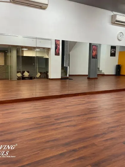 The full expanse of our wooden dance floor and mirrored wall, providing the perfect environment for learning and practice.