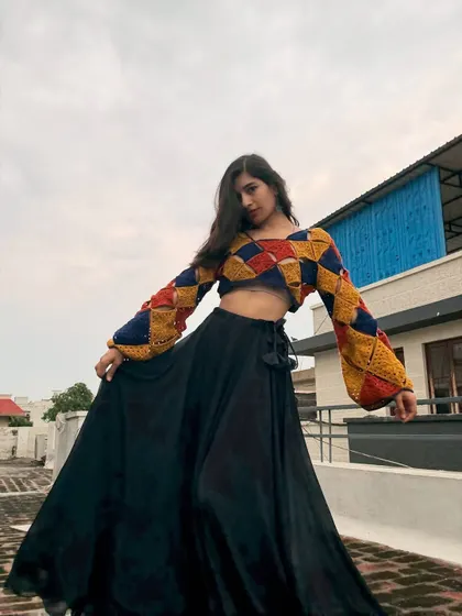 This colorful patchwork crop top is one of my favorite makes. I love playing with geometric patterns and bold colors to create something truly unique. It's made with soft cotton yarn and has fun bell sleeves, perfect for making a statement.