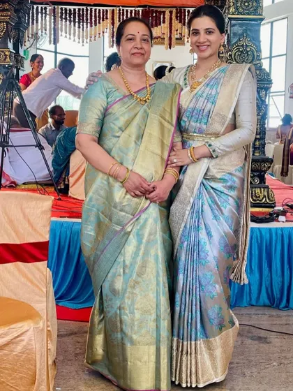 A beautiful mother-daughter moment, both looking graceful in their coordinated pastel sarees from our collection.