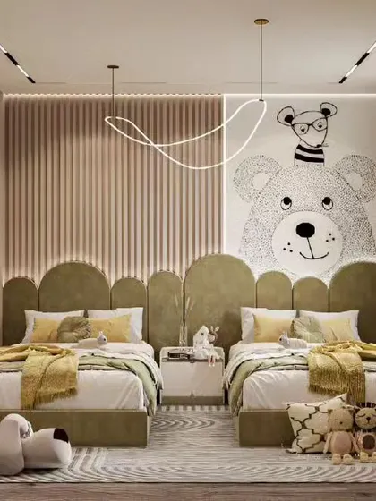 A shared bedroom with cute bear-themed wall art and individual beds, creating a cozy and charming space for siblings.