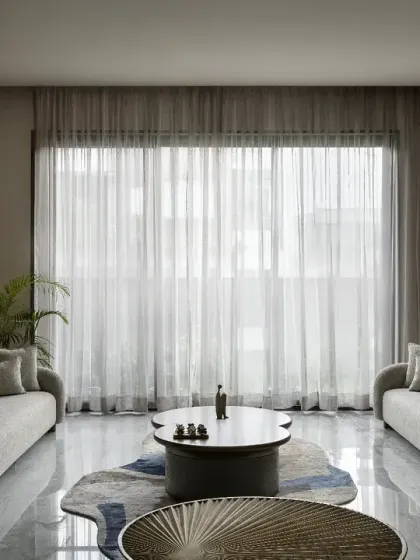 The spacious drawing room in The House of Dancing Screens comfortably seats 12-15 people. A fluid design approach pervades the furniture and furnishings, and the room opens onto a verdant, green lawn.