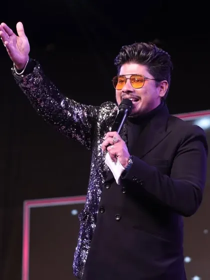 A dynamic shot of me on stage, engaging with the audience. My body language, my voice, and my energy are all focused on one thing: creating an unforgettable experience for every single person in the room.