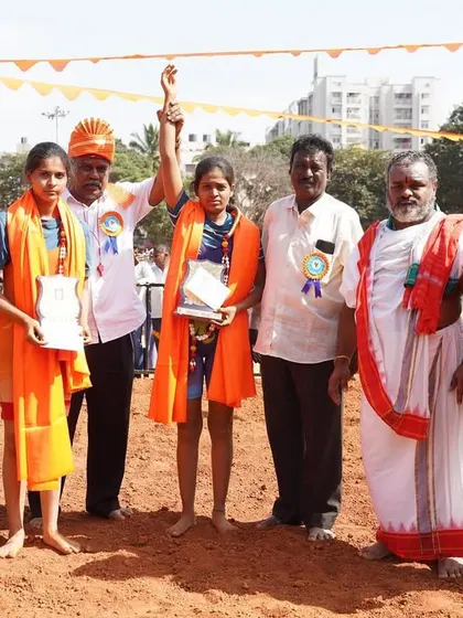 A female champion having her hand raised at the Matti Kusti event.