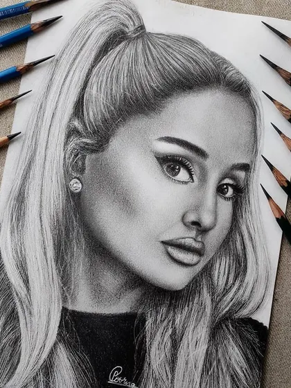 A hyper-realistic graphite portrait of Ariana Grande. I used a range of pencils from light to dark to create depth and capture a soft, yet striking expression.