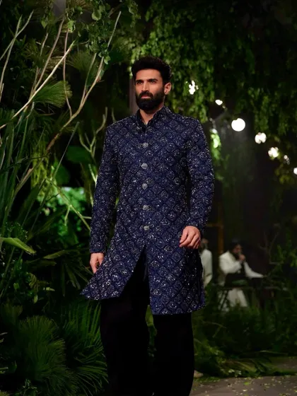 To match the raw, organic feel of Kunal Rawal's collection, I transformed the runway into a moody, primordial forest. We used giant trees and dense, wild foliage to create an environment that felt both powerful and deeply connected to nature.