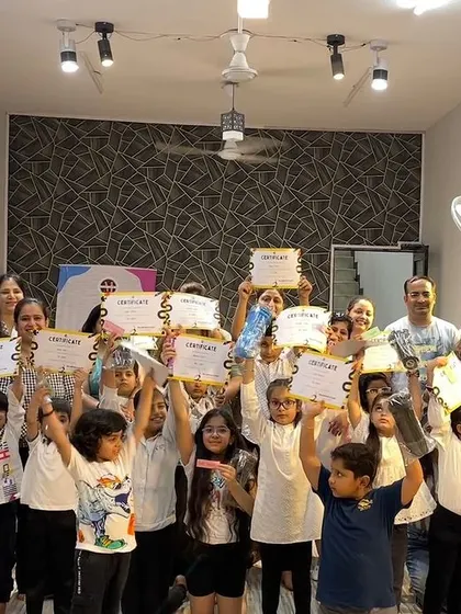 And that's a wrap on another amazing summer camp! This group photo with all the kids and their parents holding up their certificates captures the joy and sense of accomplishment we all feel at the end.