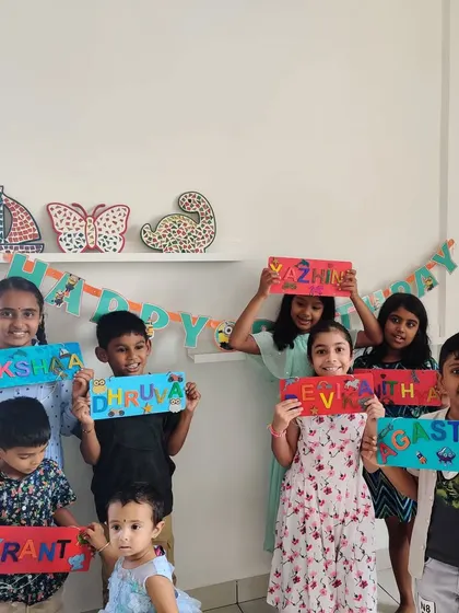 So many proud artists! The birthday group poses with their finished custom nameplates, each one a unique masterpiece.