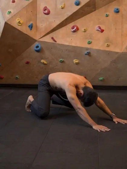The Loaded Beast is a foundational position in Animal Flow, seen here as the starting point for a Scorpion Reach. It activates the entire body and prepares you for dynamic movement.