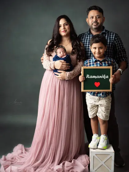 A proud big brother announces his new baby sister's name in this heartwarming family portrait.