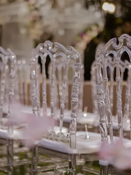 A detail shot of the elegant transparent 'ghost' chairs that lined the aisle.