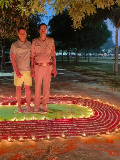 Posing with a local police officer who joined our Diwali celebration, showing community support.