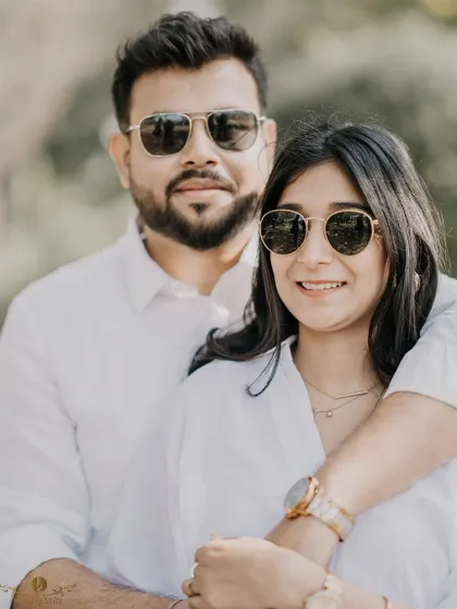 A cool, casual portrait of a couple in matching white shirts and sunglasses. This shot has a relaxed and confident vibe, perfect for a modern pre-wedding shoot.
