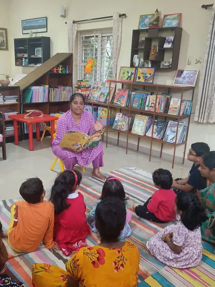 The storyteller reads with passion, drawing the children into a world of adventure and imagination.