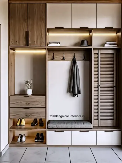 A highly functional entryway unit with a mix of open and closed storage. It includes a seating bench, drawers, shoe shelves, a coat rack, and overhead cabinets for complete organization.