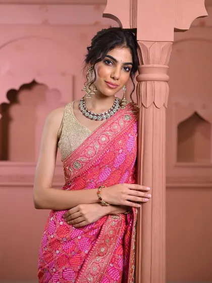 The joy of finding the perfect fit and style. This image captures the confidence that comes from wearing a piece that truly suits you, from the intricate saree to the complementary statement jewelry.
