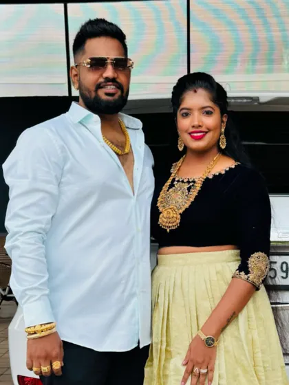 The client with her partner, her custom velvet top adding a touch of glamour to her look.