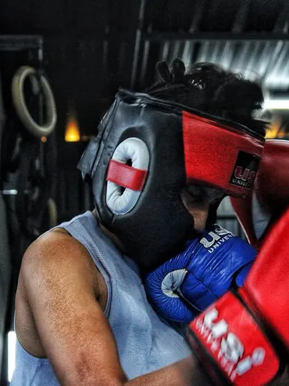 A fighter covers up under pressure during a sparring match. Defensive skills are just as important as offense, and we drill them relentlessly.
