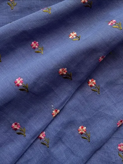 A beautiful blue embroidered linen with delicate pink floral butis, showcasing the charm of simple and subtle embroidery.