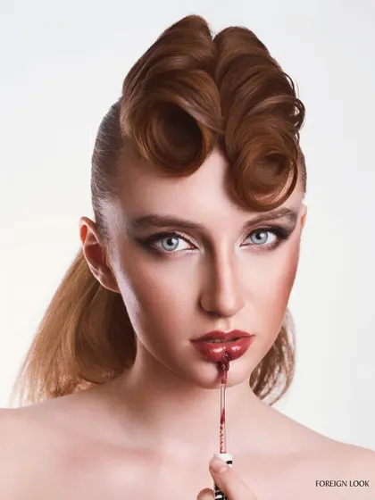 A provocative beauty shot for a lip product. The action of applying the gloss adds a dynamic element, and the high-key lighting keeps the image clean and commercial.