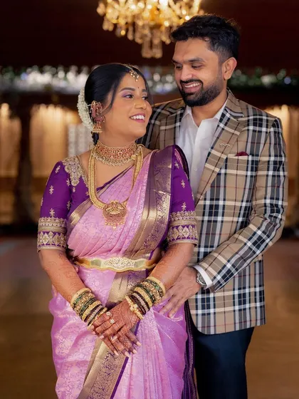 A lovely portrait of the bride and groom. Her traditional South Indian look, with a beautiful lavender saree and temple jewellery, is perfectly complemented by his classic attire.