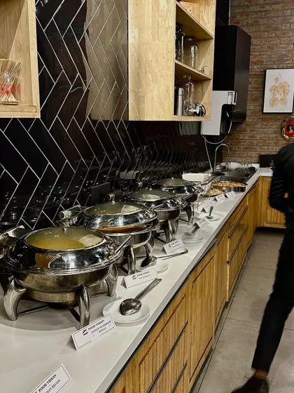A full view of the buffet line, with a variety of dishes served in elegant chafing dishes.