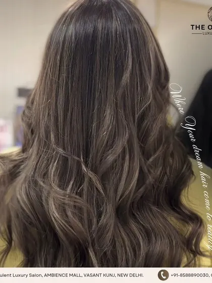 This is where your dream hair becomes a reality. This client's balayage features a beautiful blend of tones, styled into soft curls to showcase the dimension and shine.