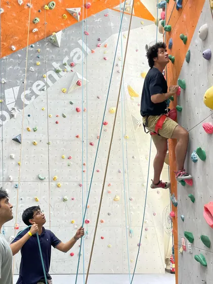 Friends belay their partner, working together to ensure a safe and successful climb.