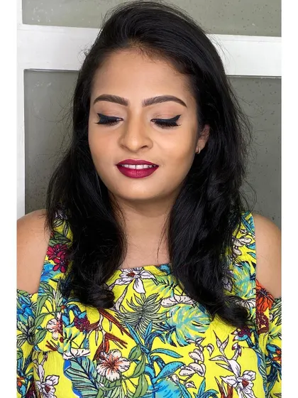 This is a great example of an "everyday glam" or party guest makeup look. It features a flawless base, a classic winged liner, and a beautiful berry lip color that's perfect for any celebration.
