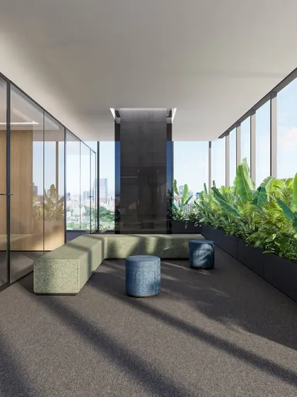 A quiet lounge area along the periphery of the Vian Office, lined with lush planters against floor-to-ceiling windows. This biophilic design element brings nature indoors, offering employees a serene space to recharge while enjoying panoramic city views.